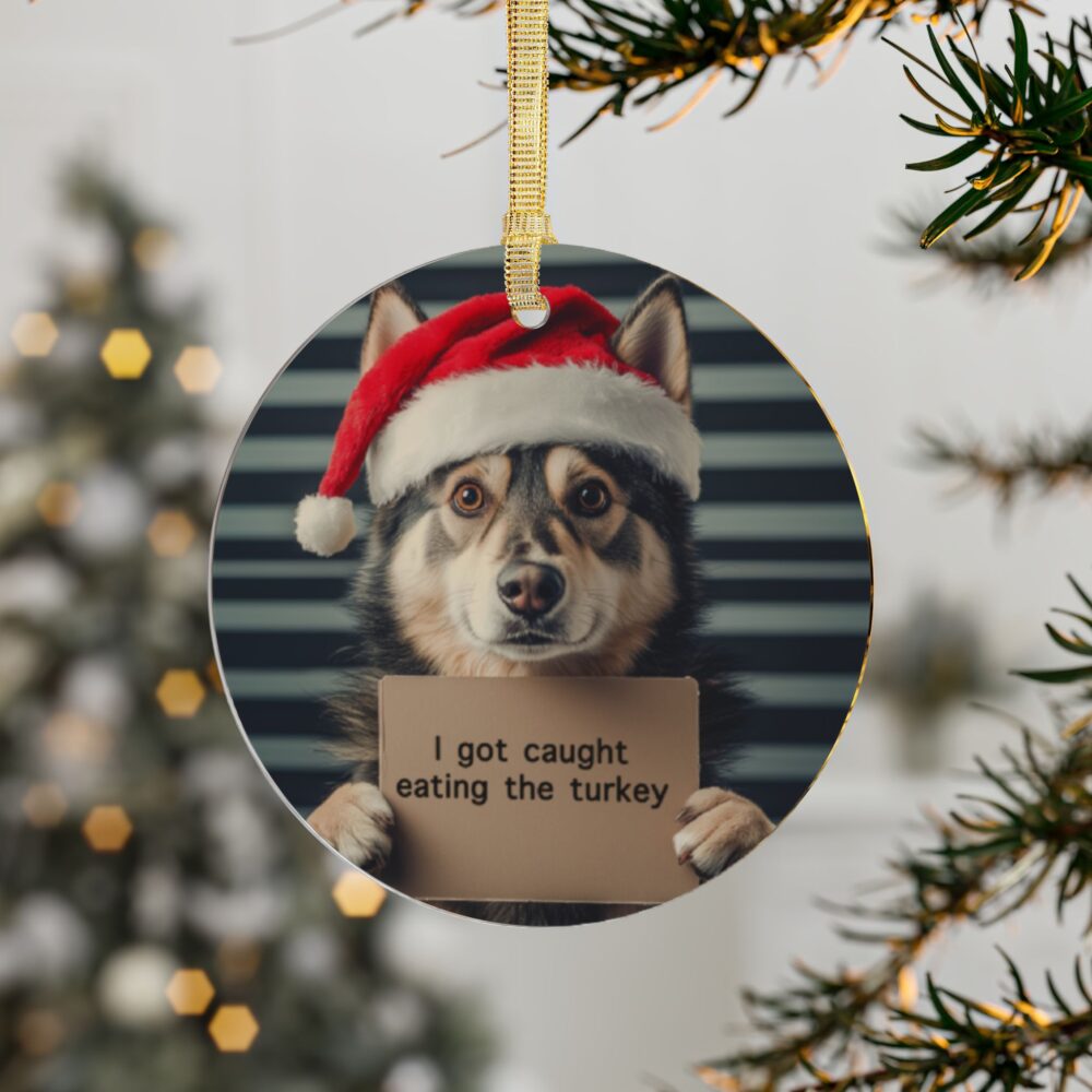 Christmas tree decorated with a funny pet-themed ornament featuring a dog wearing a Santa hat, holding a sign saying ‘I got caught eating the turkey